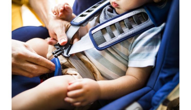father-fastening-seat-belt-for-his-son-sitting-in-PFPDESG